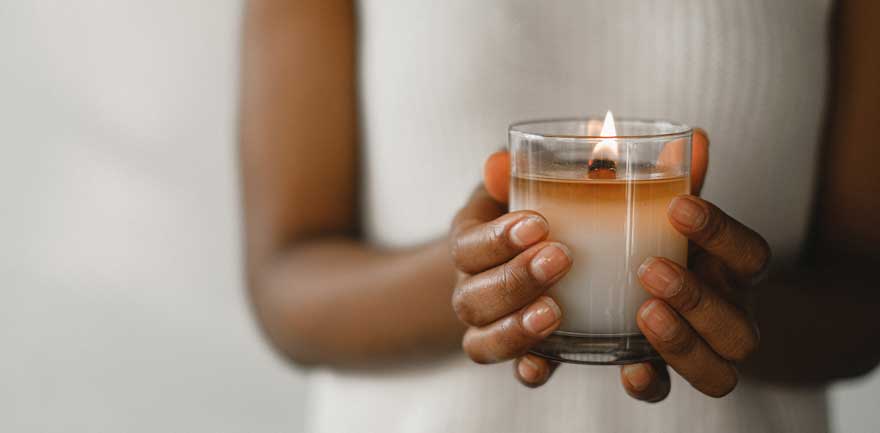 person holding a candle for a ritual