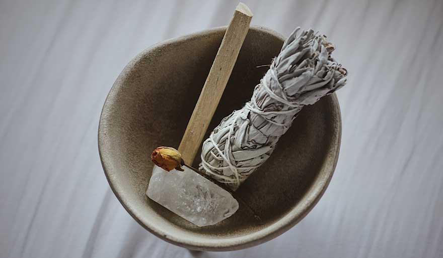 bowl with sage, crystal and wood incense